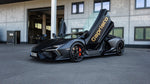 Matte grey Lamborghini Revuelto with Capristo door graphics outside the factory