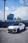 White Urus with the Vision widebody kit, front three-quarter in a lot