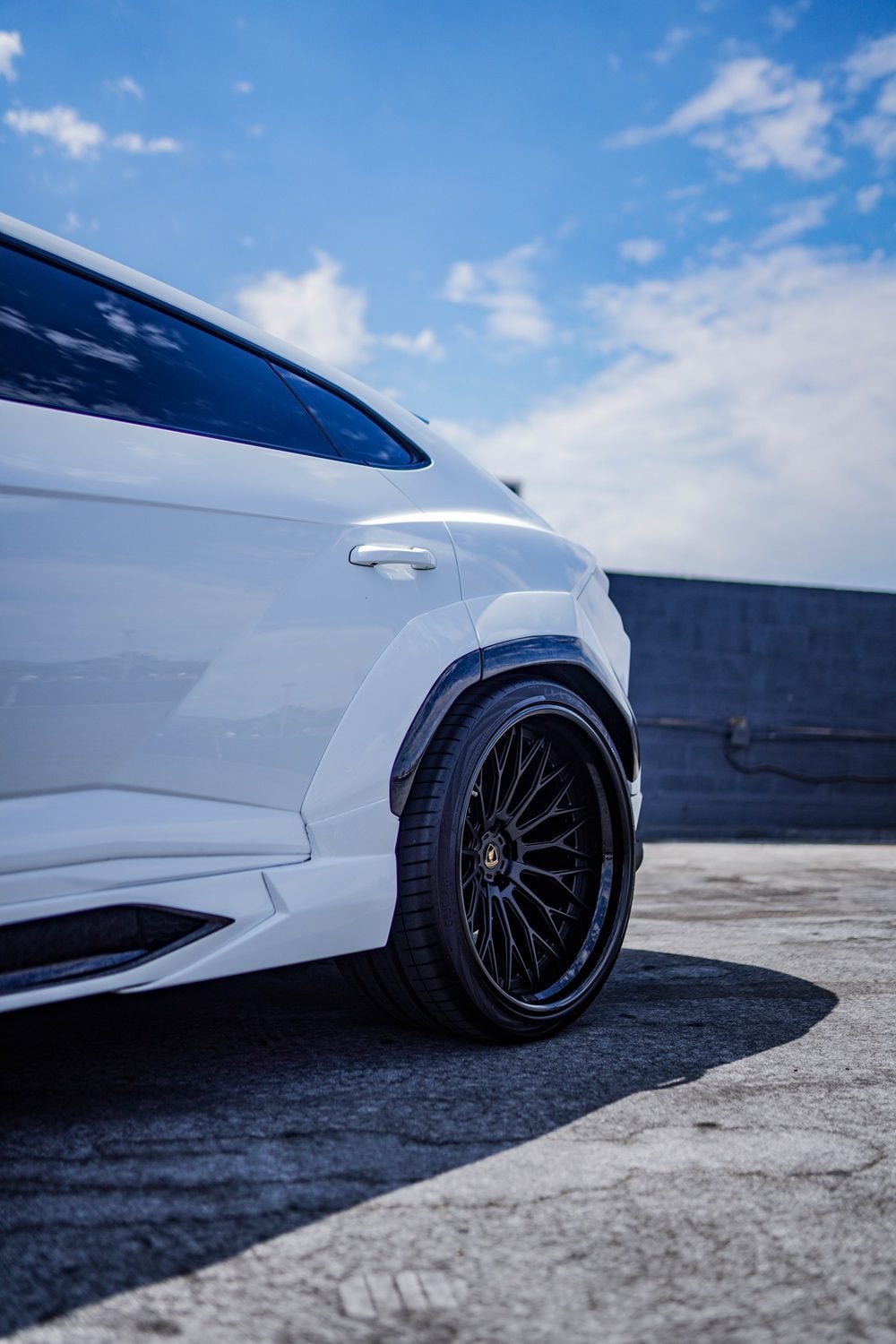 Rear widebody fender on a white Urus, low angle