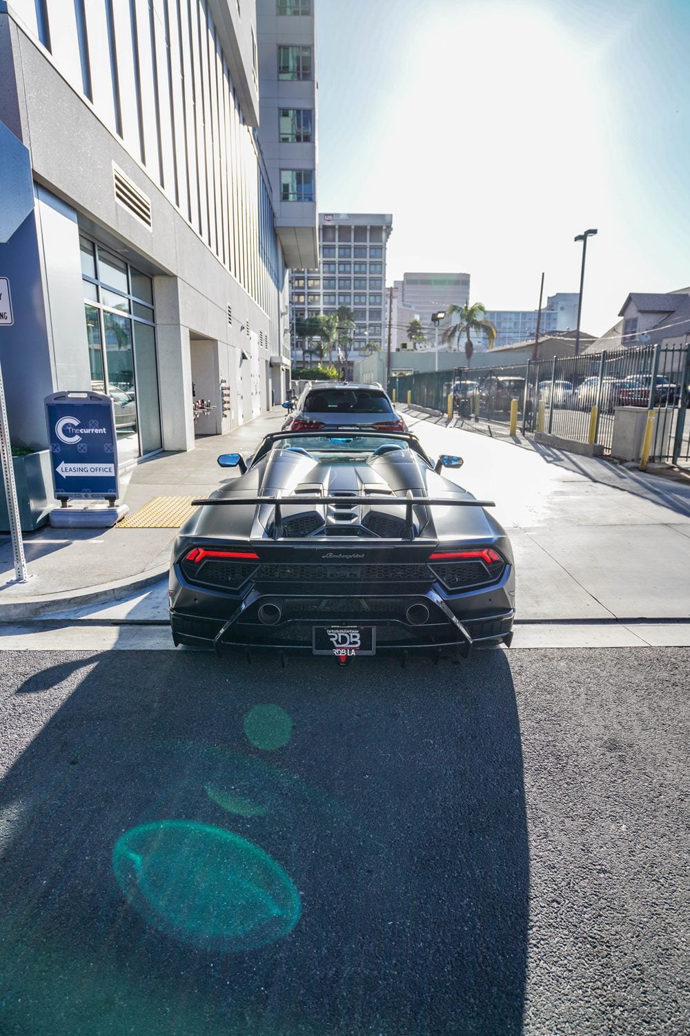 Black Huracan Performante rear view showing the diffuser on a city street