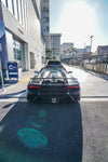 Black Huracan Performante rear view showing the diffuser on a city street