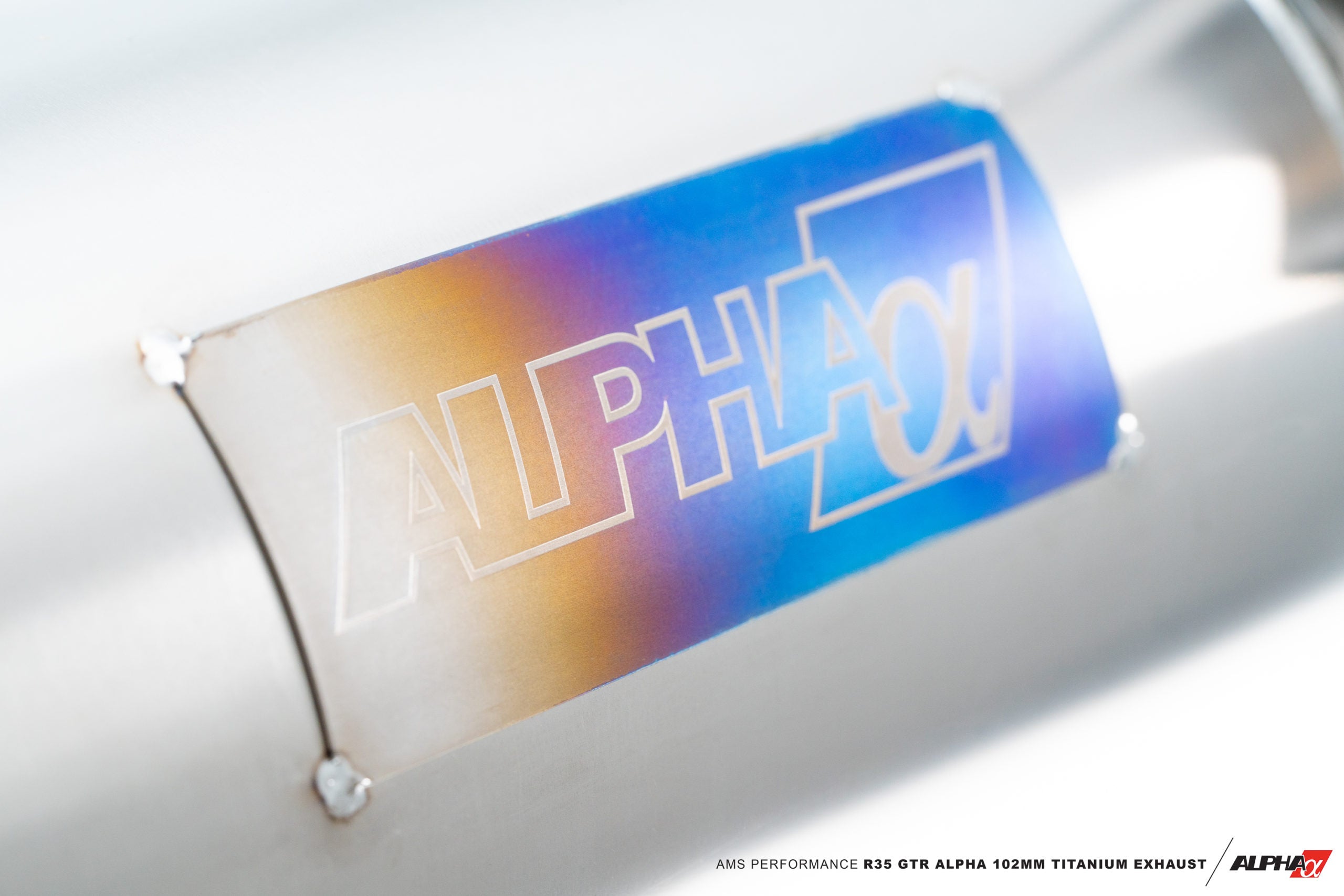 Heat-coloured titanium muffler shell with Alpha logo on the AMS GT-R exhaust