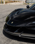 Black Ferrari SF90 front corner showing the upper front lip