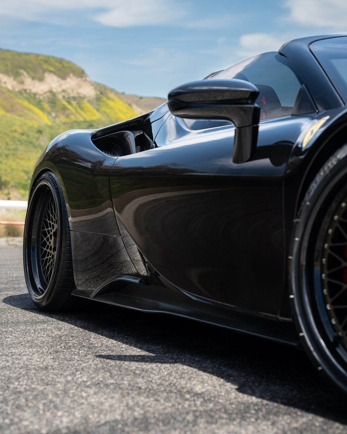 Carbon side skirt on a black Ferrari SF90 Spider