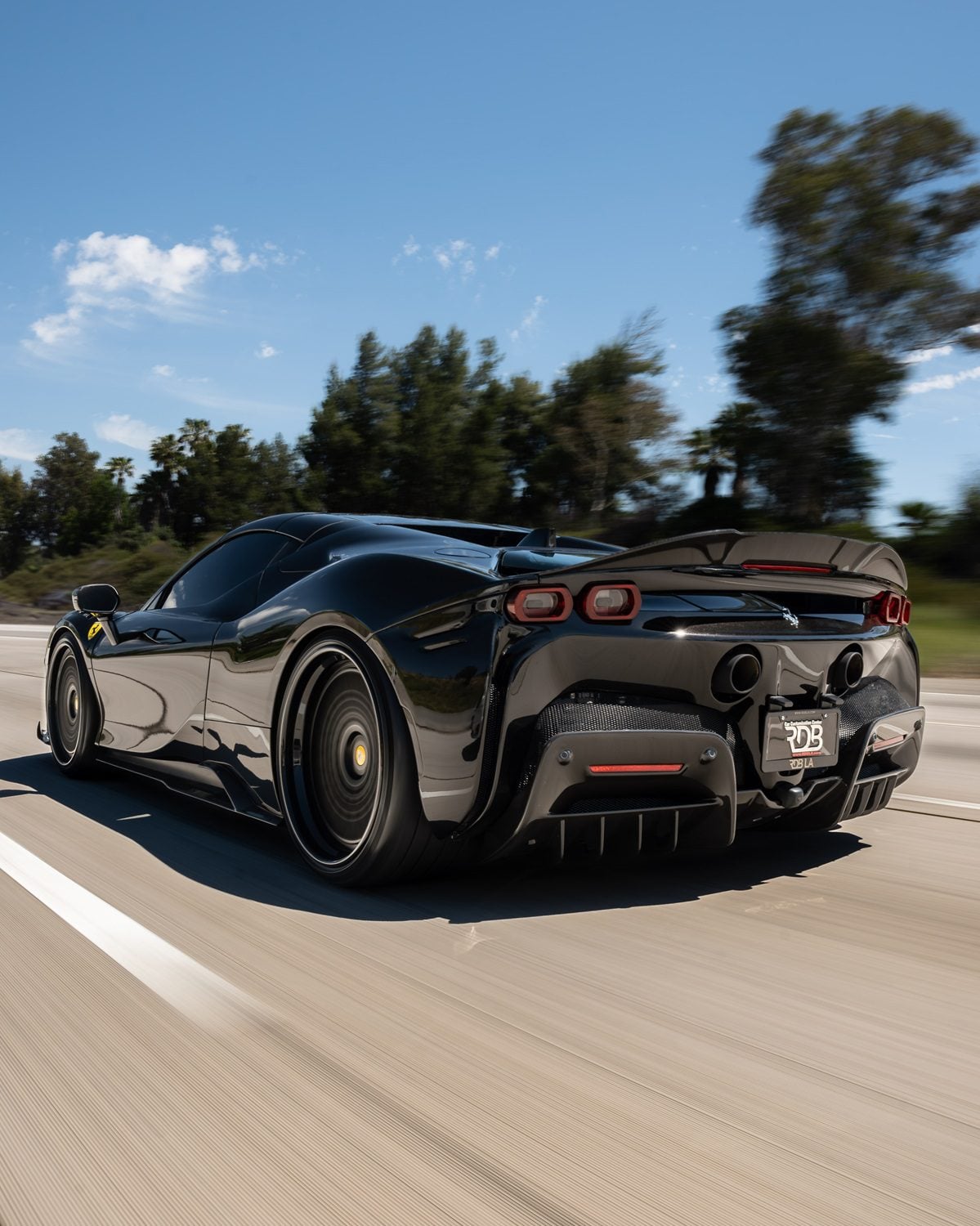 Grey Ferrari SF90 rolling shot with race spoiler