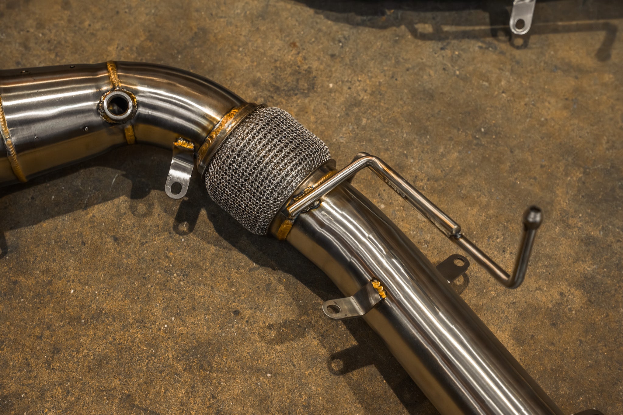 Valvetronic Designs F1 Exhaust McLaren 650S / MP4-12C manufacturer gallery: braided flex joint and welded mounting rods on a front pipe