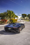Black Aventador S rear view in a lot showing the diffuser