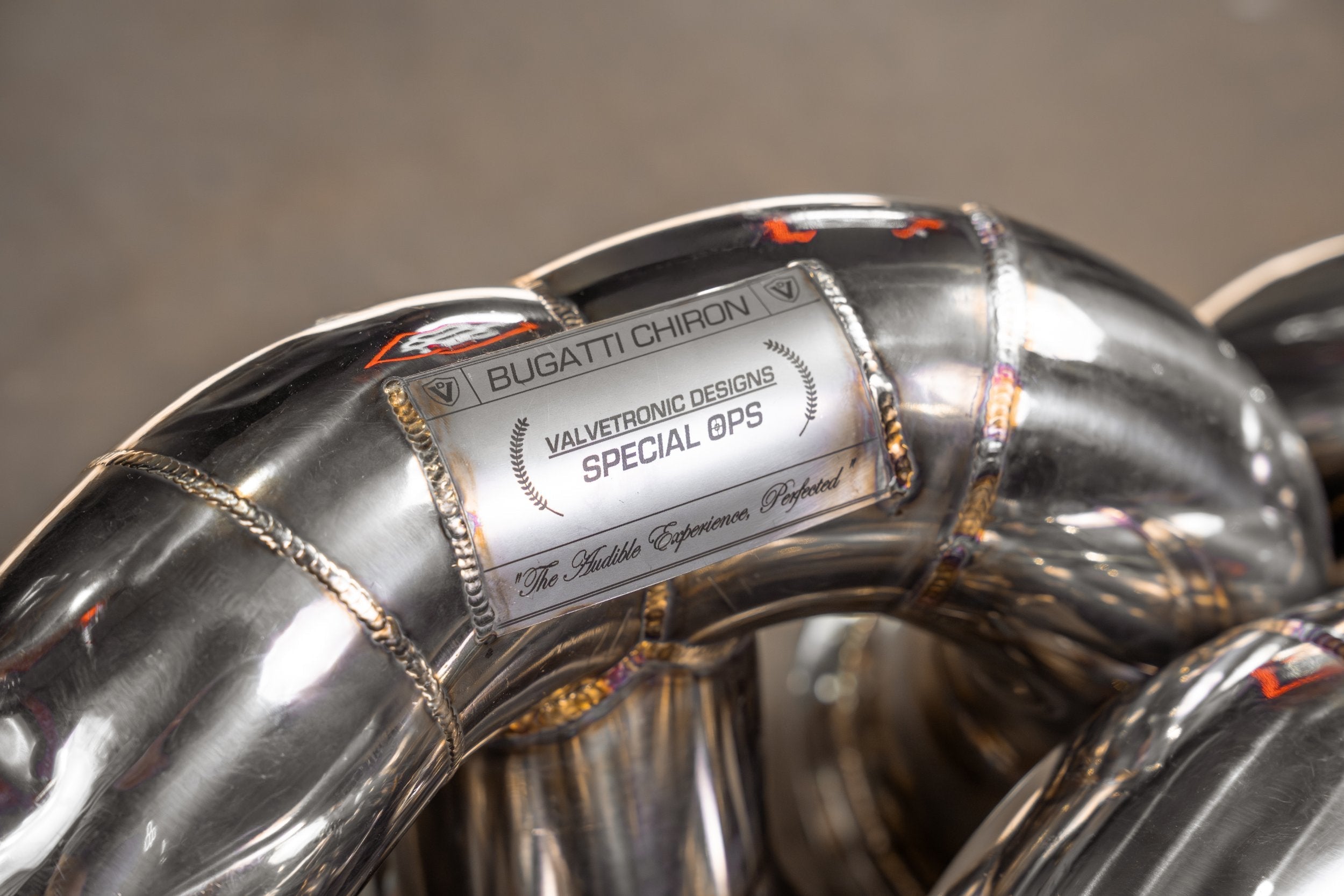 Valvetronic Designs F1 Exhaust Bugatti Chiron Pur Sport manufacturer gallery: Special 002 identification plate on a curved tube