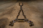 Valvetronic Designs Valved Exhaust BMW G90 M5 manufacturer gallery: complete silver-and-gold-toned exhaust laid lengthwise on the floor