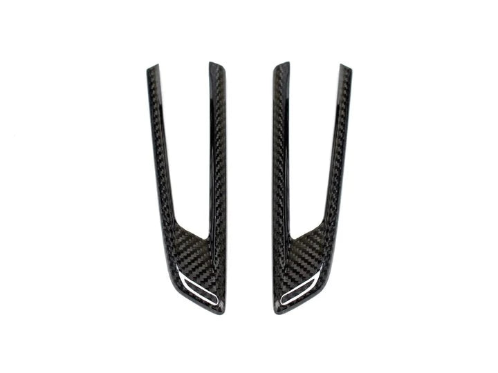 A front view of AUTOTECKNIC DRY CARBON FIBER FENDER TRIM - BMW F9X M8 2019+ with white background