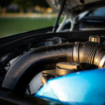 A close up view of RK Autowerks F1X M5 M6 CARBON FIBER INTAKES fitted on a car