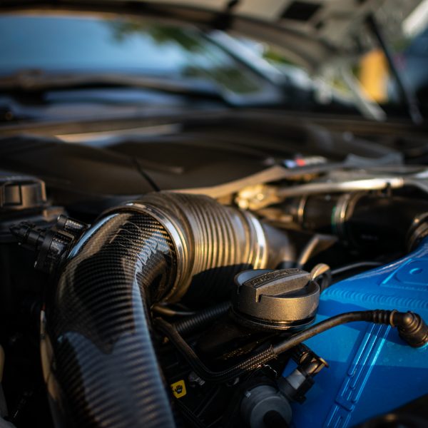 A close up view of RK Autowerks F1X M5 M6 CARBON FIBER INTAKES fitted on a car