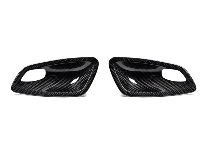 A front view of AUTOTECKNIC DRY CARBON INTERIOR DOOR HANDLE TRIM SET - BMW E82 1M | E81 / E87 / E88 1-SERIES 2007-2013 with white background