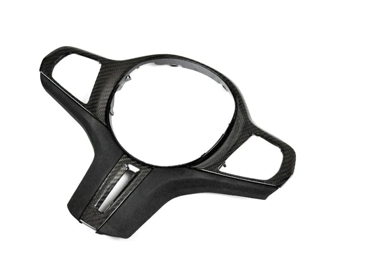 A front view of AUTOTECKNIC CARBON ALCANTARA STEERING WHEEL TRIM - BMW Models with white background