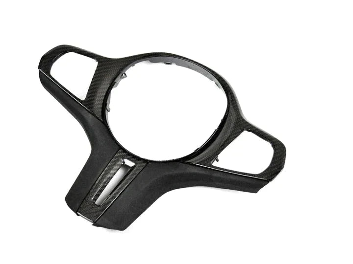 A front view of AUTOTECKNIC CARBON ALCANTARA STEERING WHEEL TRIM - BMW Models with white background
