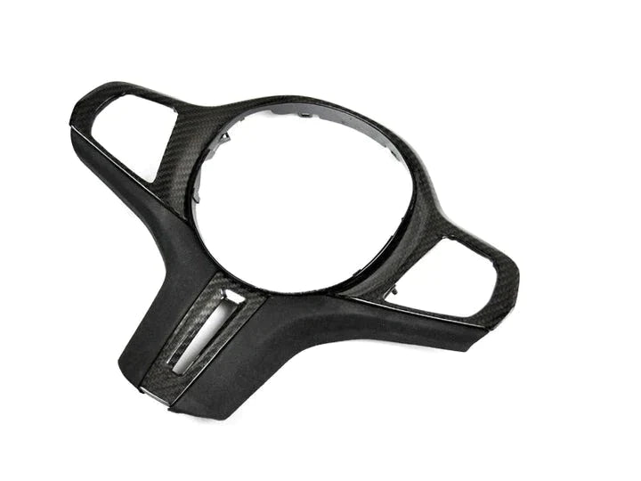 A front view of AUTOTECKNIC CARBON ALCANTARA STEERING WHEEL TRIM - BMW Models with white background