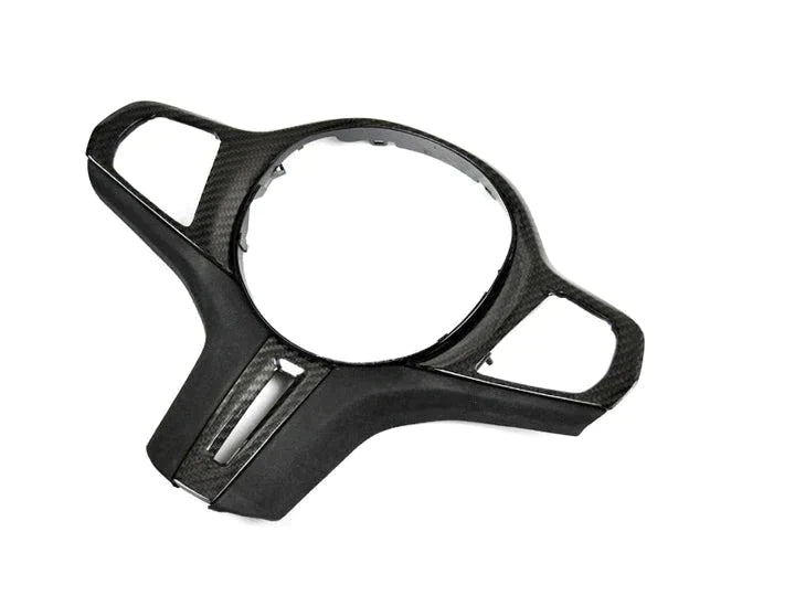 A front view of AUTOTECKNIC CARBON ALCANTARA STEERING WHEEL TRIM - BMW Models with white background