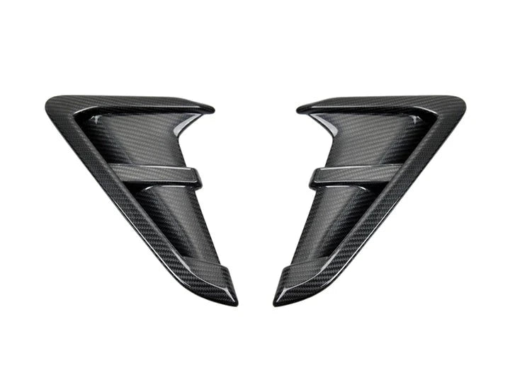 A front view of AUTOTECKNIC REPLACEMENT DRY CARBON FIBER FENDER TRIMS - BMW F97 X3M | F98 X4M | G01 X3 | G02 X4 2017+ with white background