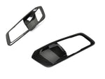 A front view of AUTOTECKNIC DRY CARBON INTERIOR DOOR HANDLE TRIM SET - BMW Models with white background