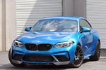 A front wide view of AUTOTECKNIC DRY CARBON FIBER CENTER FRONT LIP - BMW F87 M2 COMPETITION 2018+ fitted on a blue car