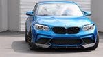 A front side wide view of AUTOTECKNIC DRY CARBON FIBER CENTER FRONT LIP - BMW F87 M2 COMPETITION 2018+ fitted on a blue car