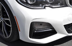 A side close up view of AUTOTECKNIC DRY CARBON FRONT BUMPER TRIM - BMW G20 330I M-SPORT 2019-2022 fitted on a white car