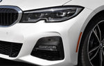 A front side view of AUTOTECKNIC DRY CARBON FRONT BUMPER TRIM - BMW G20 330I M-SPORT 2019-2022 fitted with white background