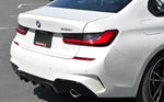 A side wide close up view of AUTOTECKNIC DRY CARBON EXTENDED-FIN COMPETITION REAR DIFFUSER  - BMW G20 3-SERIES 2019+ fitted on a white car