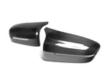 A front view of AUTOTECKNIC REPLACEMENT DRY CARBON MIRROR COVERS - BMW F9X M8 2019+ with white background