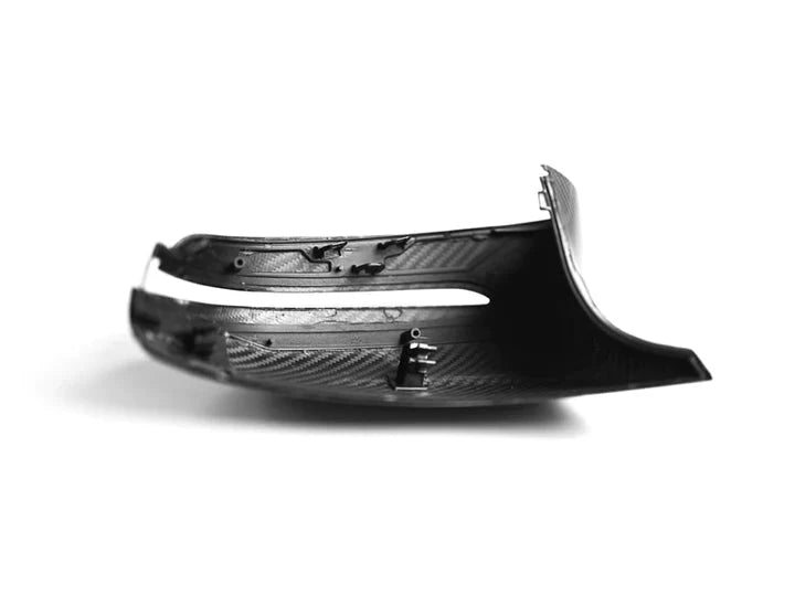 A back view of one of the AUTOTECKNIC REPLACEMENT DRY CARBON MIRROR COVERS - BMW F9X M8 2019+ with white background