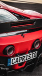 Capristo tips with red inserts on a red Ferrari SF90, rear view
