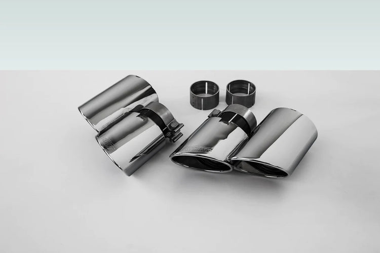 A front view of TECHART Exhaust Tail Pipes, glossy chrome for Porsche Macan S / Turbo with a plain background