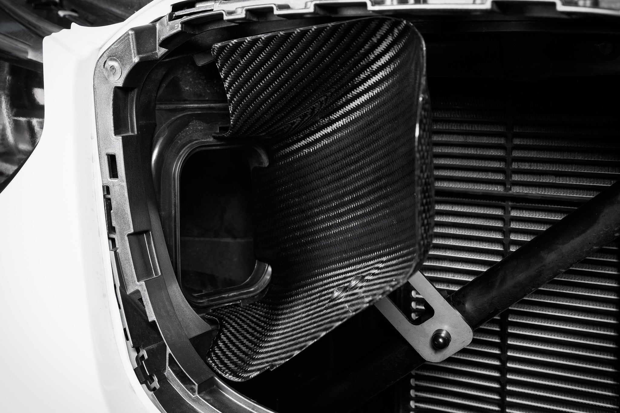Black carbon fiber intake lid with contoured scoops installed in engine bay air intake housing - Eventuri intake lid with scoops for BMW X3M