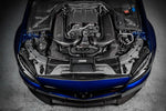 Carbon fiber intake system with curved tubes installed in blue Mercedes engine bay with V8 engine visible - Eventuri intake for Mercedes-Benz C63