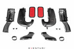 Complete carbon fiber intake system kit with curved tubes, red filters, airboxes and mounting hardware laid out symmetrically - Eventuri intake for Mercedes-Benz C63