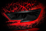 Black carbon fiber headlamp duct with angular vents against dramatic red and black geometric artistic background - Eventuri headlamp race duct for Audi RS3