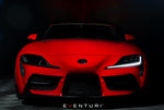 Red Toyota Supra front view with black carbon fiber air ducts flanking headlights in dark setting - Eventuri headlamp duct for Toyota Supra