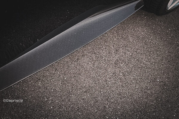close side view of Capristo Carbon Fiber Side Skirts (with Small Fin) for Ferrari Roma 2020-2024 fitted inside a car