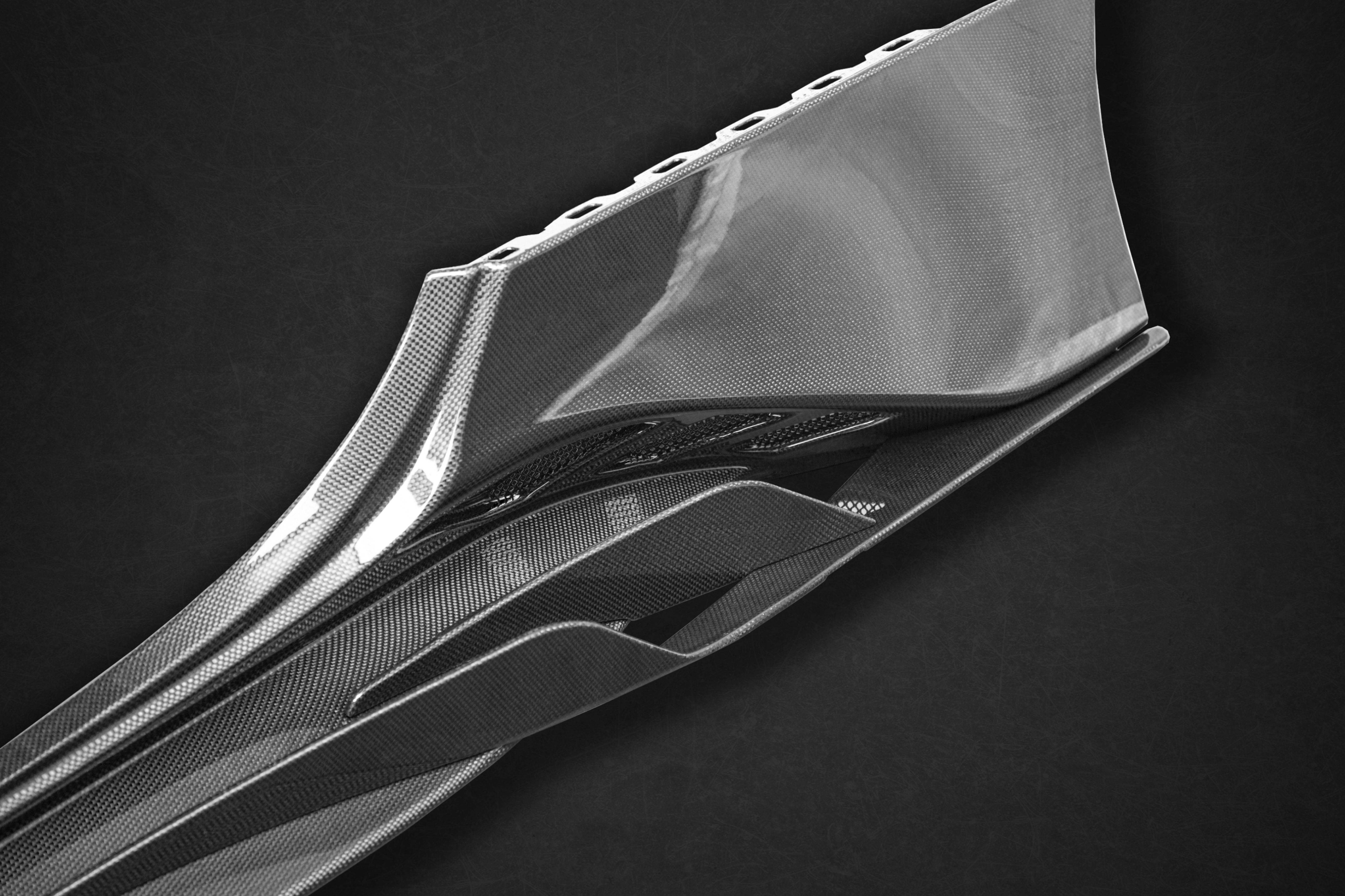 Close-up of Capristo 488 side skirt winglet and carbon weave
