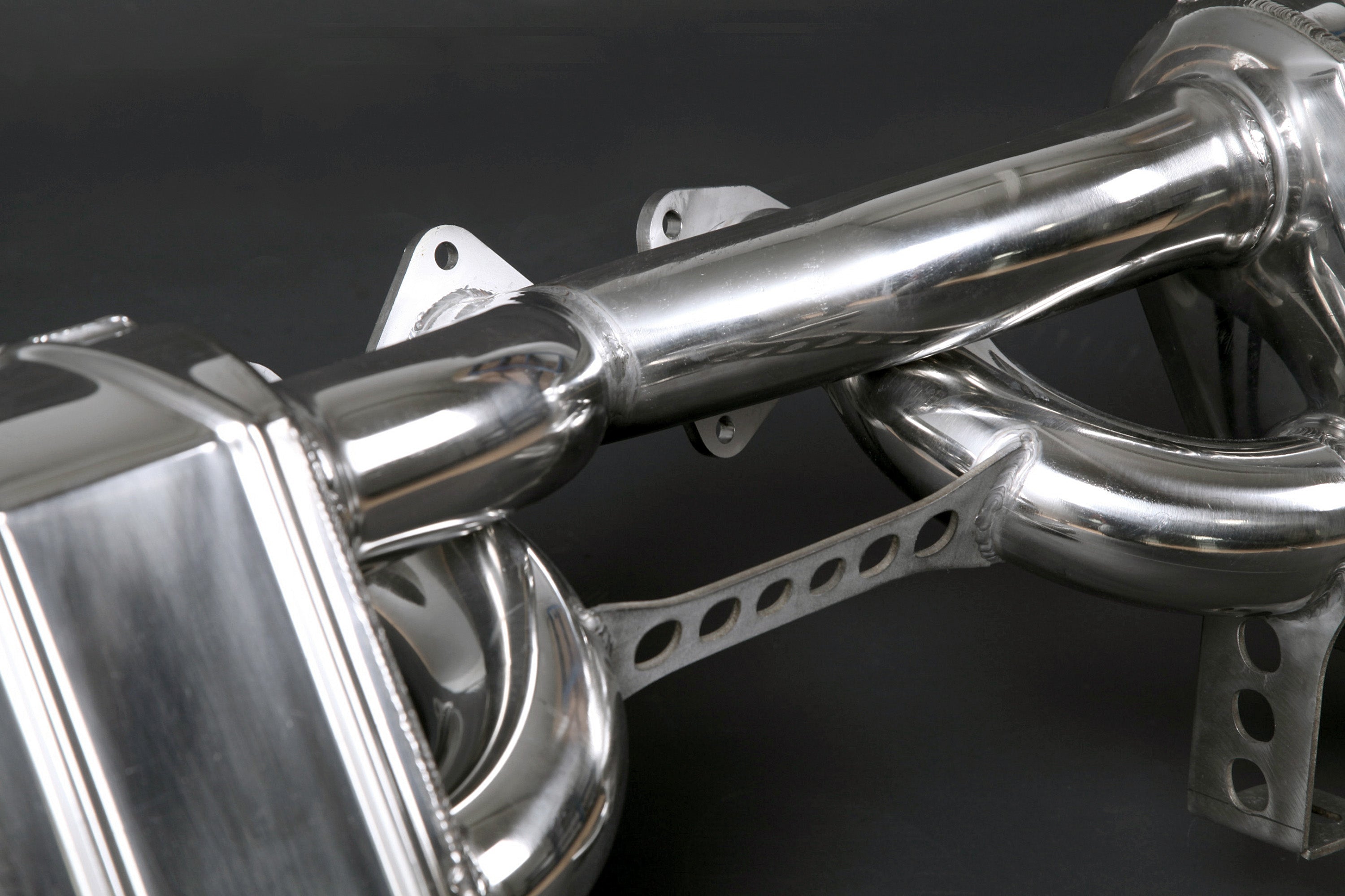 Close-up of polished muffler and bracket on Capristo Ferrari 288 GTO exhaust