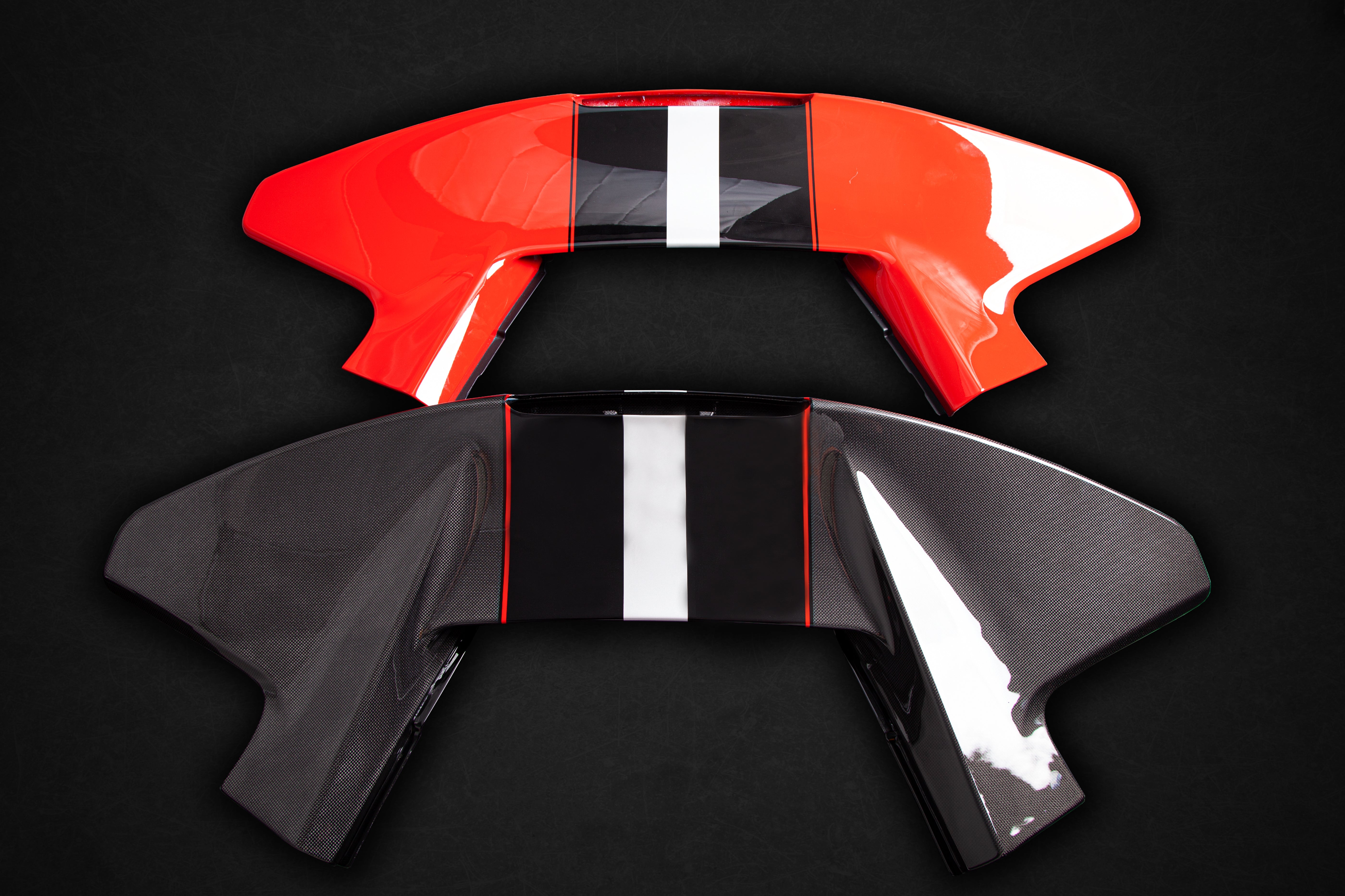 Capristo carbon 488 Pista wing above a painted red version for comparison
