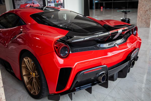 wide view of Capristo Carbon Fiber Rear Bumper for Ferrari 488 Pista 2018-2020 fitted inside a red car