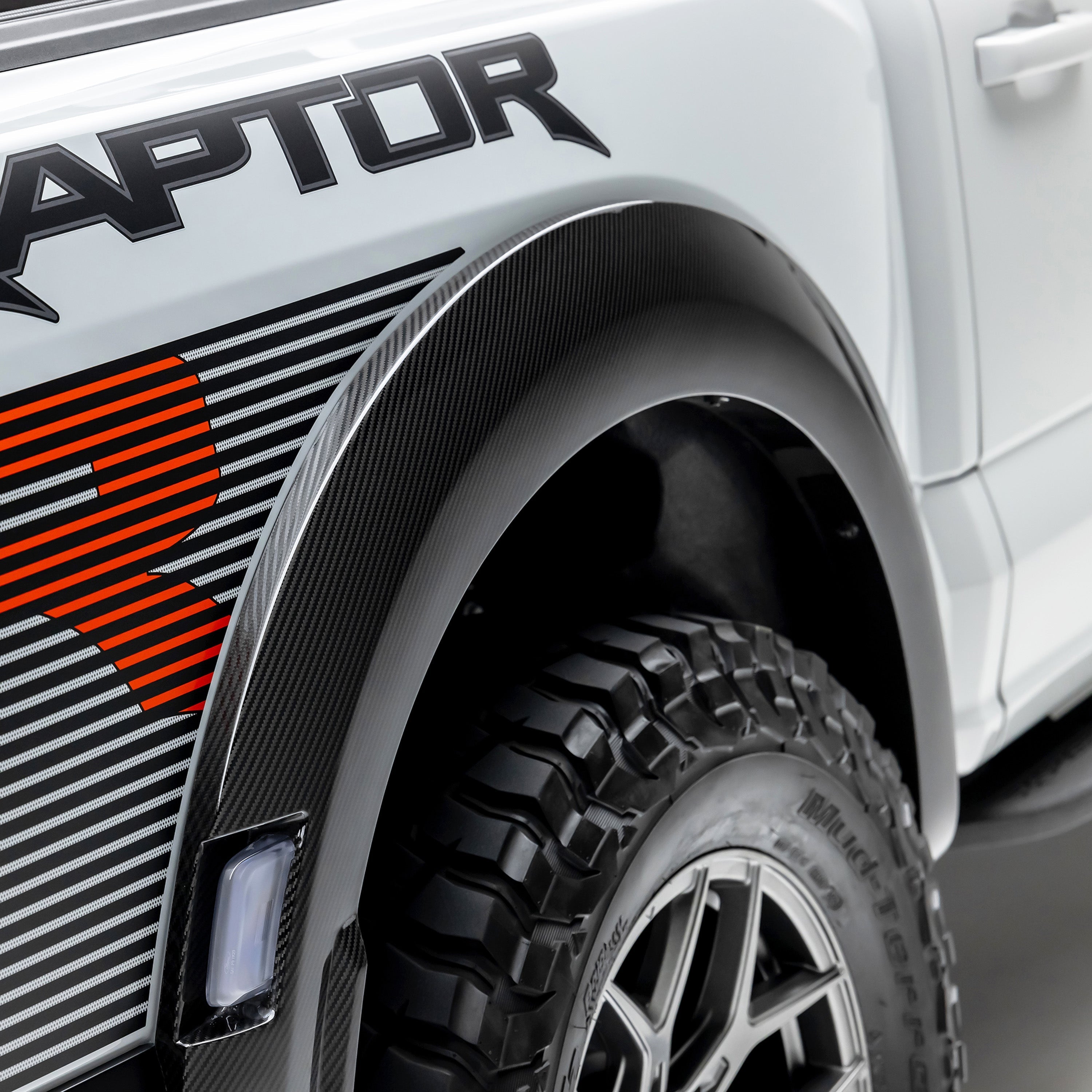 Carbon rear fender flare by Raptor bedside graphic, close-up