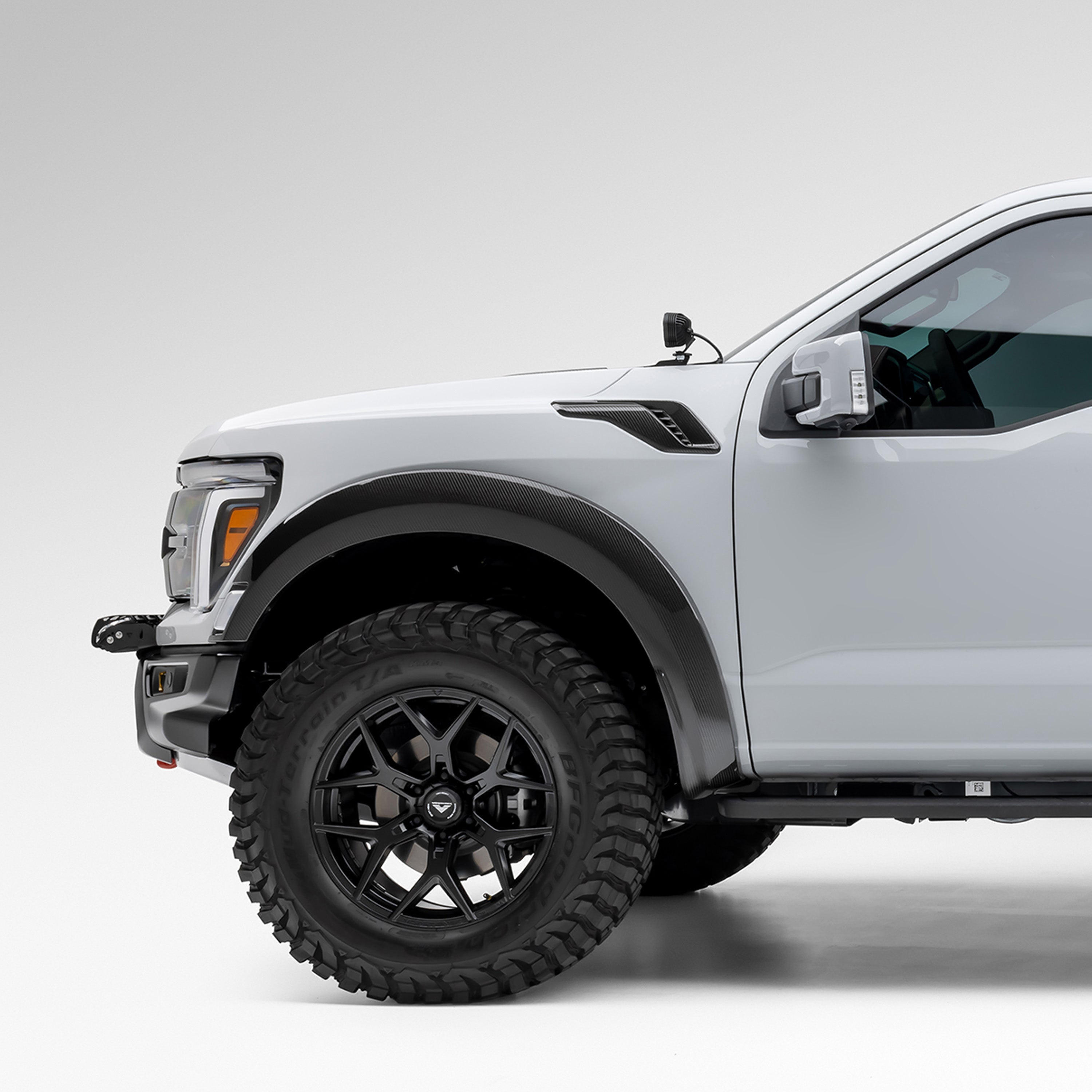 White Raptor R with carbon fender vents, front 3/4 view