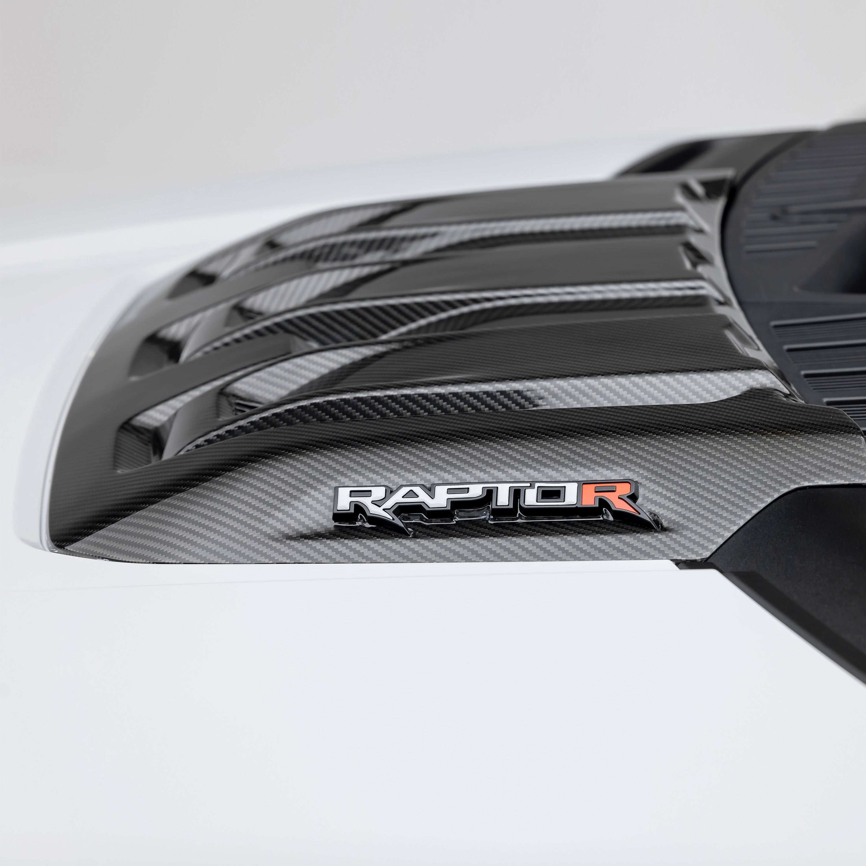 Carbon Raptor R hood scoop with Raptor R badge, side close-up