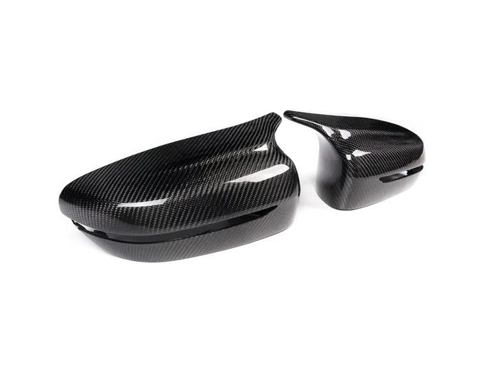 A side wide view of AUTOTECKNIC M-INSPIRED CARBON FIBER MIRROR COVERS - BMW G22 4-SERIES 2020+ with white background