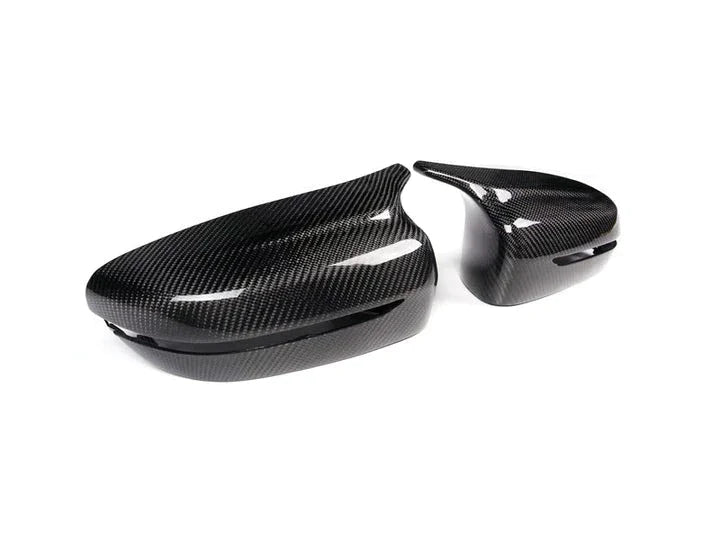 A side wide view of AUTOTECKNIC M-INSPIRED CARBON FIBER MIRROR COVERS - G20 3-SERIES 2018+ with white background