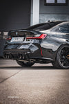 Black BMW M3 G80 with Capristo valved exhaust and quad tips, rear quarter