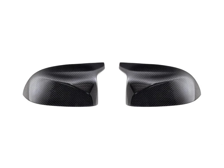 A front view of AUTOTECKNIC REPLACEMENT DRY CARBON MIRROR COVERS - BMW F95 X5M | F96 X6M 2019+ with white background