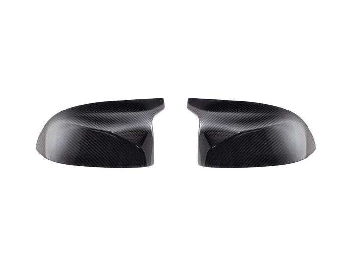 A front view of AUTOTECKNIC REPLACEMENT DRY CARBON MIRROR COVERS - BMW G09 XM 2022+ with white background